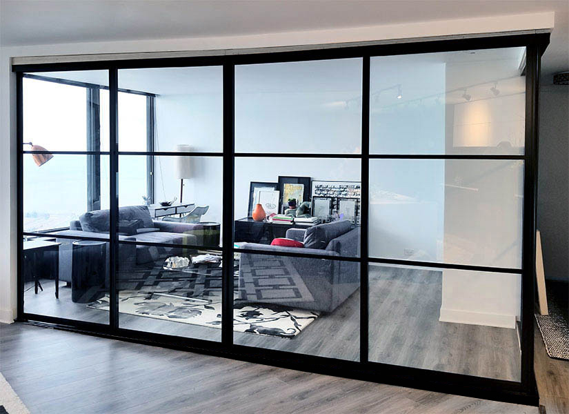 living area glass dividers with glass corner and black grid pattern