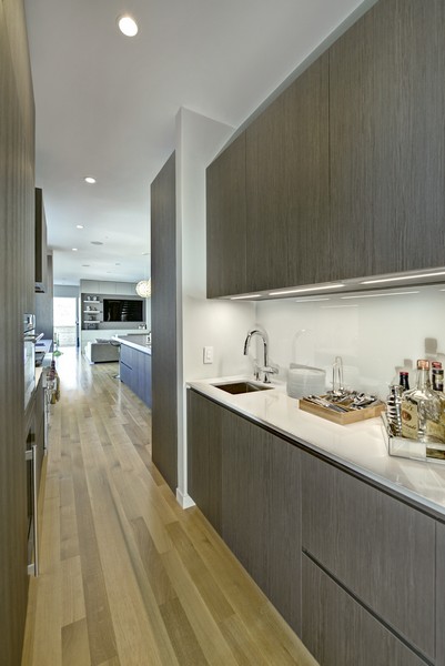 modern grey kitchen cabinets with seamless pure white glass backsplash
