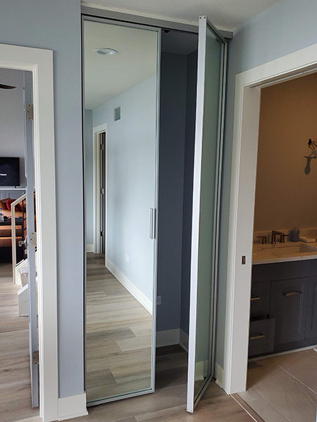 Closet Organizer with Sliding Aluminum Doors and Painted Glass